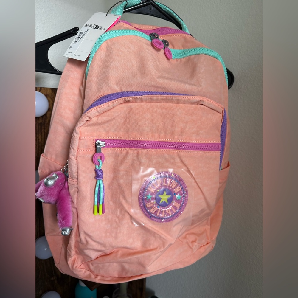 Kipling Coral Pink Backpack with Teal Trim and Purple Accents